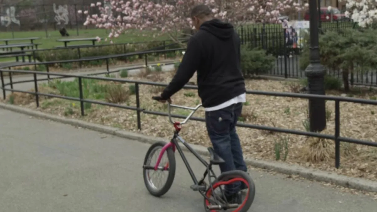 Desmond Rhodes on his BMX in a New York park